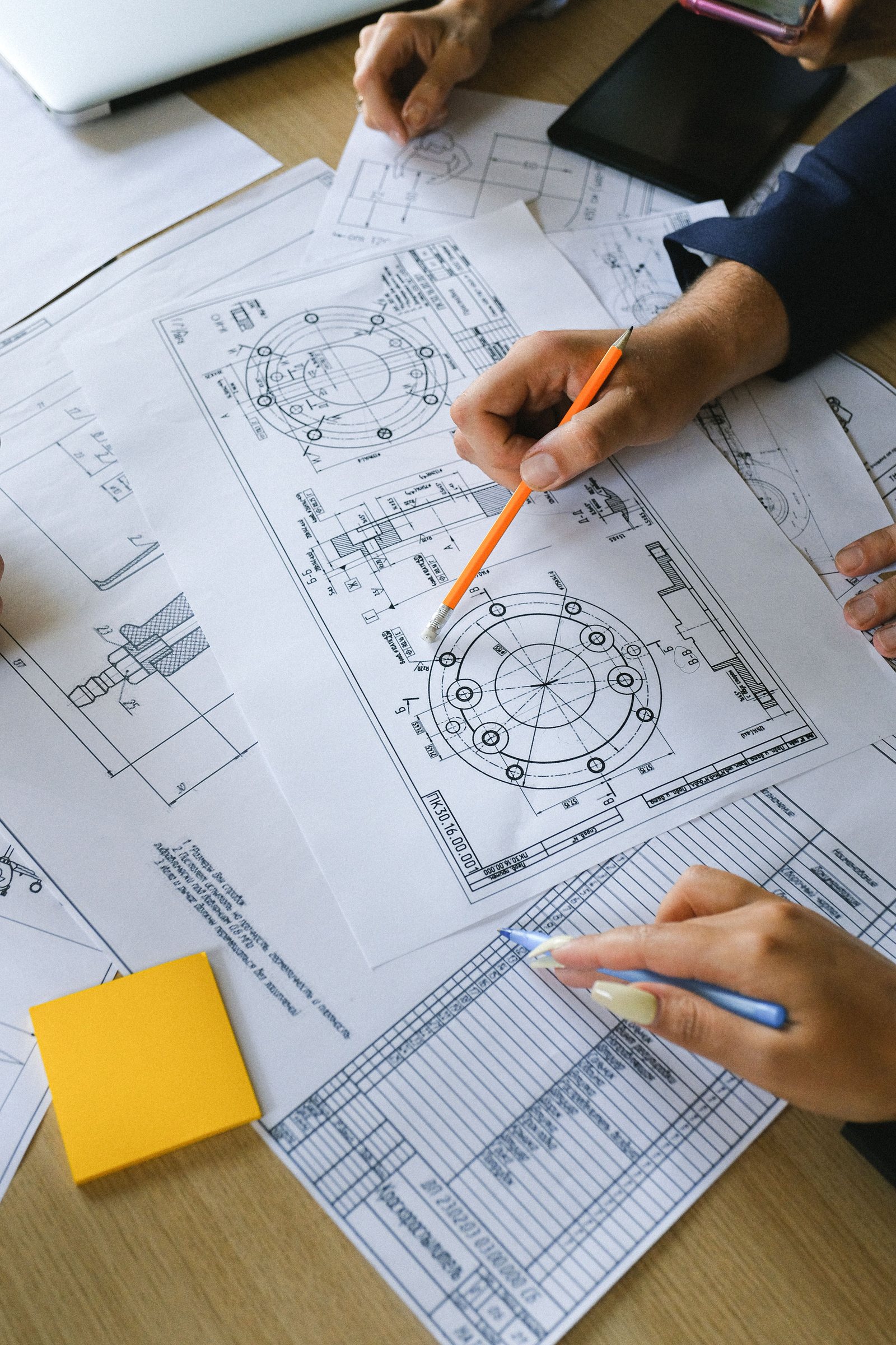 Engineers reviewing technical drawings together